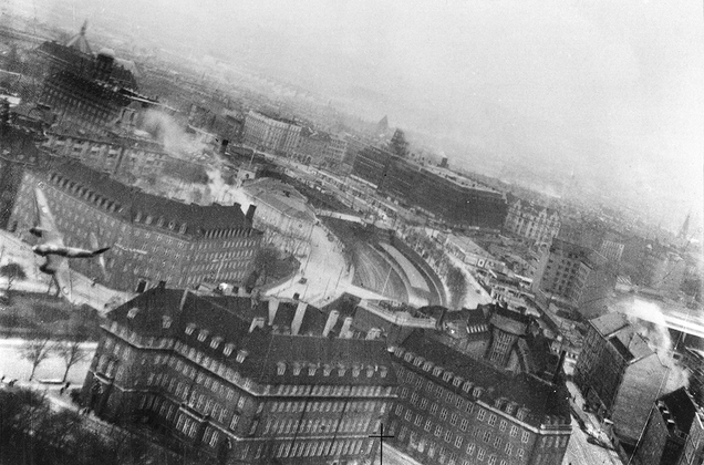 A Mosquito banks low over the city of Copenhagen, Denmark during Operation Carthage on March 21, 1945. While the target of the mission, the Gestapo headquarters, was destroyed by 20 Mosquito bombers, 125 civilians, including 86 schoolchildren, died when their school was mistakenly bombed. (Author unknown)